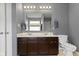 Modern bathroom features a double sink vanity, gray walls, and a toilet, offering comfort and style at 3511 Limesprings Ln, Whitestown, IN 46075