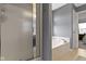 Bathroom features a glass-enclosed shower, a large soaking tub, gray walls, and tile flooring for a luxurious feel at 3511 Limesprings Ln, Whitestown, IN 46075