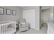 Cozy Bedroom boasts a white crib, comfortable rocking chair, soft gray walls, and ample closet space at 3511 Limesprings Ln, Whitestown, IN 46075