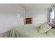 Bright bedroom boasts neutral walls, plush carpeting, a ceiling fan, and a cozy queen-sized bed with light green covers at 3511 Limesprings Ln, Whitestown, IN 46075