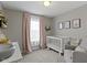Charming Bedroom with a white crib, soft gray walls, and a cozy rocking chair, creating a peaceful space at 3511 Limesprings Ln, Whitestown, IN 46075