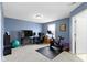 Bonus room with blue accent wall, exercise equipment and office space at 3511 Limesprings Ln, Whitestown, IN 46075
