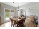 Bright dining area with wood floors, wooden dining set and walk-out to patio at 3511 Limesprings Ln, Whitestown, IN 46075