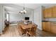 Cozy dining room featuring wood table, hanging light fixture and open floor plan to the living room at 3511 Limesprings Ln, Whitestown, IN 46075