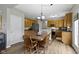 Dining area with wood table, surrounded by kitchen, appliances and flooring at 3511 Limesprings Ln, Whitestown, IN 46075