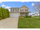 Charming two-story home featuring a well-manicured lawn and attached two-car garage at 3511 Limesprings Ln, Whitestown, IN 46075