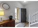 Bright foyer with hardwood floors, staircase, and decorative mirror, creating a welcoming entrance at 3511 Limesprings Ln, Whitestown, IN 46075