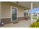 Inviting front porch with seating, brick accents, and decorative features by the door at 3511 Limesprings Ln, Whitestown, IN 46075