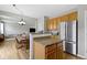 Kitchen and dining area with wood cabinets and stainless steel appliances at 3511 Limesprings Ln, Whitestown, IN 46075