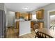 Well-lit kitchen with wood cabinets, stainless steel appliances, and a kitchen island at 3511 Limesprings Ln, Whitestown, IN 46075