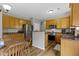 Kitchen with wood cabinets, stainless steel appliances and center island with breakfast bar at 3511 Limesprings Ln, Whitestown, IN 46075