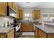 Kitchen with stainless steel appliances, wood cabinets and granite countertops at 3511 Limesprings Ln, Whitestown, IN 46075