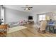 Bright, spacious living room featuring hardwood floors, comfortable seating, and a ceiling fan at 3511 Limesprings Ln, Whitestown, IN 46075