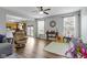 Open living area with hardwood floors connecting to a well-lit dining and kitchen space at 3511 Limesprings Ln, Whitestown, IN 46075
