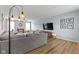 Spacious living room with hardwood floors, sectional sofa, and modern lighting at 3511 Limesprings Ln, Whitestown, IN 46075