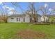 Expansive backyard with a well-maintained lawn, wooden deck, and view of the home's exterior at 3724 W 42Nd Ter, Indianapolis, IN 46228