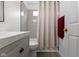 Updated bathroom features a bathtub with a gray tiled wall and neutral curtain at 3724 W 42Nd Ter, Indianapolis, IN 46228