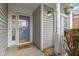 Inviting front porch with a storm door, white columns, and a welcoming 'hello' doormat at 3724 W 42Nd Ter, Indianapolis, IN 46228