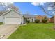 Well-maintained single-story home featuring a two-car garage and a lush green lawn at 3724 W 42Nd Ter, Indianapolis, IN 46228