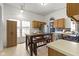 Kitchen with light wood cabinets, tile floors, and breakfast nook with a rustic table and seating at 3724 W 42Nd Ter, Indianapolis, IN 46228