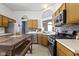Kitchen with stainless steel appliances, light wood cabinets, tile backsplash, and breakfast table at 3724 W 42Nd Ter, Indianapolis, IN 46228