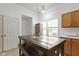 Kitchen with light wood cabinets, tile floors, and breakfast nook with table at 3724 W 42Nd Ter, Indianapolis, IN 46228