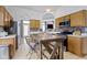 Kitchen with stainless steel appliances, light wood cabinets, tile backsplash, and breakfast table at 3724 W 42Nd Ter, Indianapolis, IN 46228