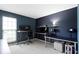Well-lit office space with built-in desks, modern monitors, and natural light from a large window at 3724 W 42Nd Ter, Indianapolis, IN 46228