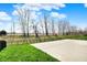 Spacious concrete patio overlooking a green lawn and line of trees at 4941 Oak Hill Dr, Lebanon, IN 46052