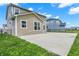The rear exterior of the house displays the concrete patio that is surrounded by grass at 4941 Oak Hill Dr, Lebanon, IN 46052