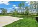 Spacious concrete patio is surrounded by lush green grass and a black metal fence at 4941 Oak Hill Dr, Lebanon, IN 46052