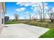 Large backyard patio with partial fence overlooking trees at 4941 Oak Hill Dr, Lebanon, IN 46052