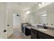 Bright bathroom featuring double vanity with granite counters, tile floors, and large mirror at 4941 Oak Hill Dr, Lebanon, IN 46052