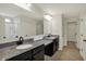 Bright bathroom featuring double vanity with granite counters, tile floors, large mirror, and glass enclosed shower at 4941 Oak Hill Dr, Lebanon, IN 46052