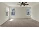 Bright bedroom features carpet and two large windows, creating a peaceful sanctuary to unwind and relax at 4941 Oak Hill Dr, Lebanon, IN 46052