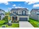 Charming two-story home with brick and neutral tone siding, a two-car garage, and a well-manicured front lawn at 4941 Oak Hill Dr, Lebanon, IN 46052