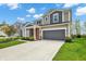 Charming home exterior with gray accents, well-manicured lawn and a driveway at 4941 Oak Hill Dr, Lebanon, IN 46052