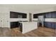 Spacious kitchen features dark cabinets, stainless steel appliances, and a large center island, perfect for cooking at 4941 Oak Hill Dr, Lebanon, IN 46052