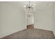 Cozy living room with carpet and stylish light fixture, looking into the foyer at 4941 Oak Hill Dr, Lebanon, IN 46052