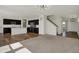 Open living space with a kitchen, stairs and carpeted living area at 4941 Oak Hill Dr, Lebanon, IN 46052