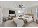 Comfortable bedroom features a ceiling fan, natural light, and neutral tones to create a welcoming retreat at 4941 Oak Hill Dr, Lebanon, IN 46052