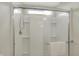 Shower features sliding glass doors, tiled walls, shelving and modern fixtures at 4941 Oak Hill Dr, Lebanon, IN 46052