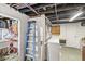 Unfinished basement featuring storage space, exposed utilities, and a utility sink at 5028 Graceland Ave, Indianapolis, IN 46208