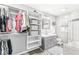 Bathroom with vanity, open closet and shower over tub with glass screen at 5028 Graceland Ave, Indianapolis, IN 46208