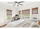 Bright bedroom with a work space, ceiling fan and views from the large windows at 5028 Graceland Ave, Indianapolis, IN 46208