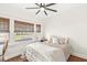 Cozy bedroom with natural light, a ceiling fan, and a comfortable, inviting bed at 5028 Graceland Ave, Indianapolis, IN 46208