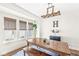 Cozy dining room with natural light, rustic wood table, bench seating, and modern light fixture at 5028 Graceland Ave, Indianapolis, IN 46208