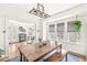 Inviting dining room featuring hardwood floors, natural light, and view into the living area at 5028 Graceland Ave, Indianapolis, IN 46208