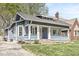 Charming blue home with a cozy front porch and well-maintained landscaping at 5028 Graceland Ave, Indianapolis, IN 46208