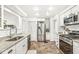 Spacious kitchen featuring stainless steel appliances, granite countertops, and tiled flooring at 5028 Graceland Ave, Indianapolis, IN 46208